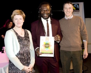 Phil Haughton (Better Food MD) Lucy Gatward (Better Food Marketing Manager) and Levi Roots, Colston Hall, March 13, Fairtrade South West Business Award (credit: Jon Craig)