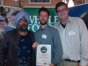 Shop Supervisor Ian Cross and Assistant Manager Edward Temple receiving the award with broadcaster Hardeep Singh Kohli. 